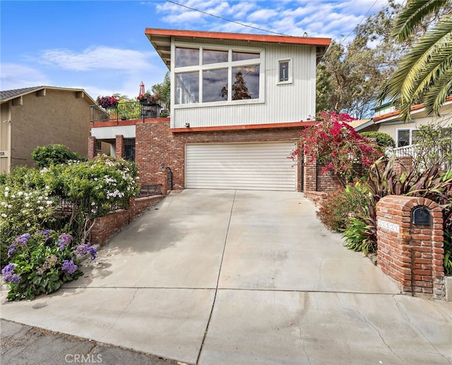 21521 Anns Ln, Laguna Beach, CA 92651 - view of front of house with driveway, a garage, and brick siding