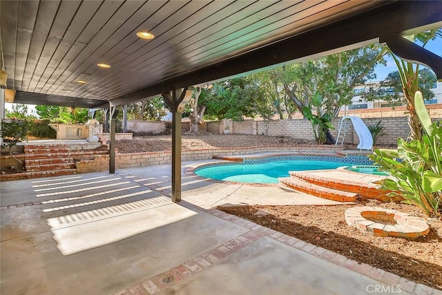20591 Celtic St, Chatsworth, CA 91311 - view of swimming pool with a water slide, a patio, and a fenced backyard