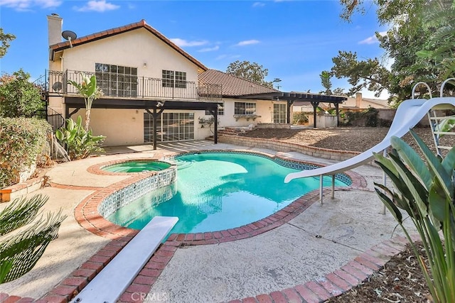 20591 Celtic St, Chatsworth, CA 91311 - view of swimming pool with a water slide, a diving board, a patio, a fenced backyard, and a pool with connected hot tub