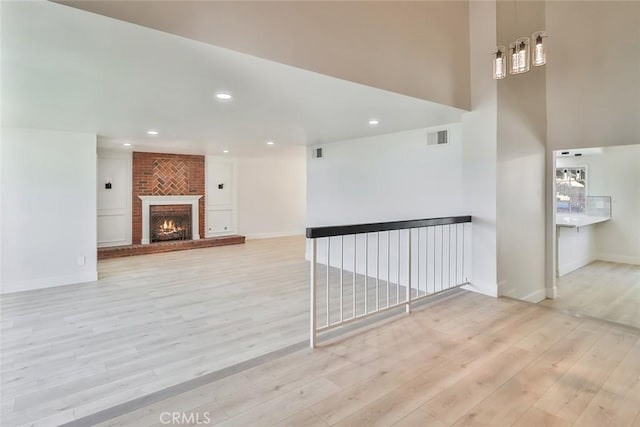 20591 Celtic St, Chatsworth, CA 91311 - unfurnished living room with light wood-style flooring, a fireplace, and recessed lighting