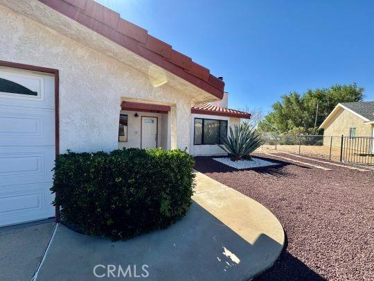 2748 Delmar Ave, Mojave, CA 93501 - view of exterior entry featuring stucco siding