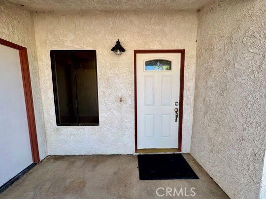 2748 Delmar Ave, Mojave, CA 93501 - doorway to property with stucco siding