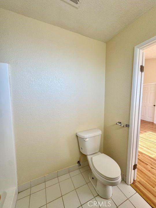 2748 Delmar Ave, Mojave, CA 93501 - bathroom featuring toilet and tile patterned flooring