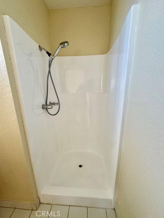 2748 Delmar Ave, Mojave, CA 93501 - full bath with a shower stall and tile patterned floors