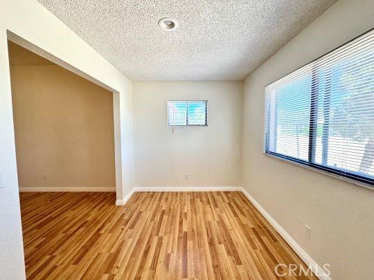 2748 Delmar Ave, Mojave, CA 93501 - unfurnished room featuring a textured ceiling and light wood-type flooring