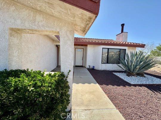 2748 Delmar Ave, Mojave, CA 93501 - entrance to property with a chimney and stucco siding