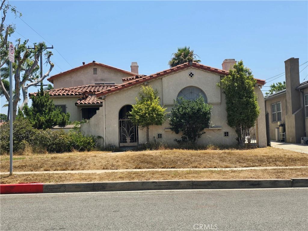 3500 W 78th St, Inglewood, CA 90305 - mediterranean / spanish-style house with stucco siding, a tiled roof, and a chimney