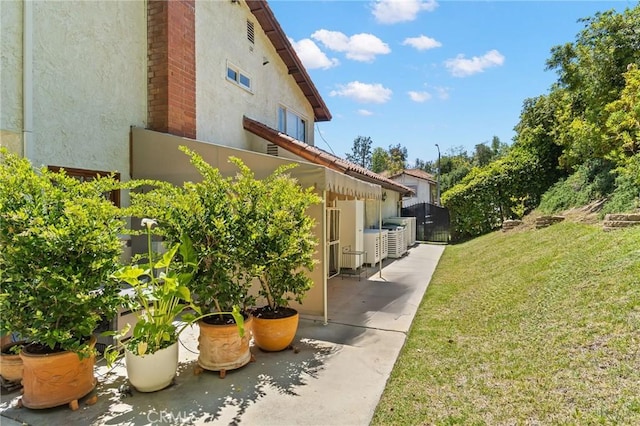 10411 Windtree Dr, Los Angeles, CA 90077 - view of side of property featuring stucco siding and a patio area
