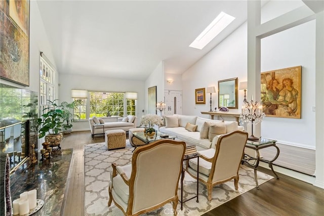 10411 Windtree Dr, Los Angeles, CA 90077 - living area featuring wood finished floors, high vaulted ceiling, and a skylight