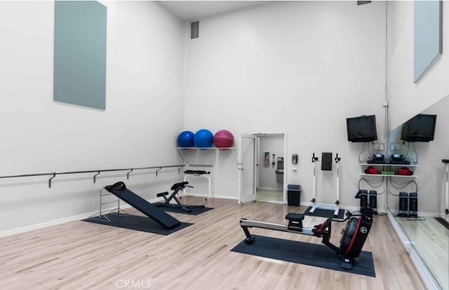 10411 Windtree Dr, Los Angeles, CA 90077 - workout room with wood finished floors and a high ceiling