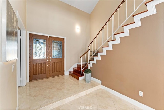 4360 E Addington Dr, Anaheim, CA 92807 - foyer featuring stairs, a towering ceiling, french doors, marble finish flooring, and inlaid floor details