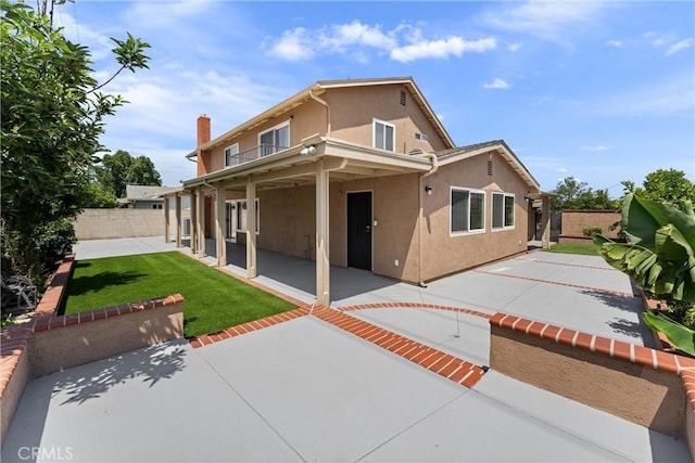 4360 E Addington Dr, Anaheim, CA 92807 - back of property featuring stucco siding, a patio, a fenced backyard, and a balcony