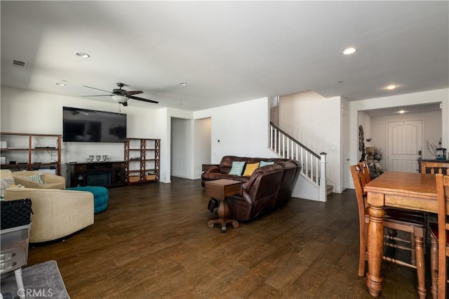 18094 Olivenhain Dr, Riverside, CA 92508 - living room with stairway, ceiling fan, dark wood-style floors, recessed lighting, and a glass covered fireplace