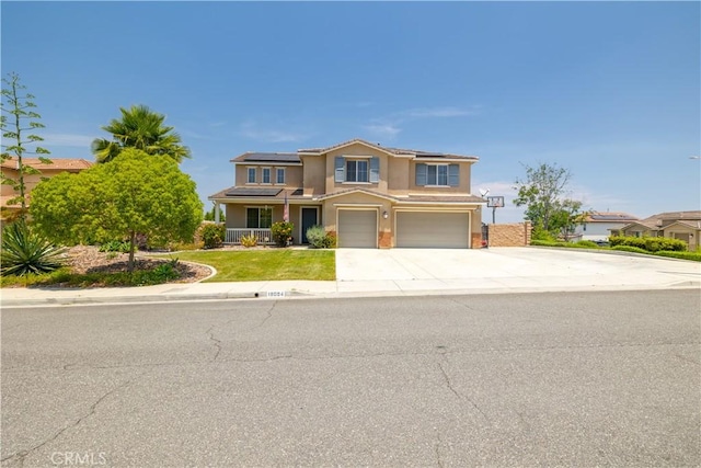 18094 Olivenhain Dr, Riverside, CA 92508 - traditional-style house featuring an attached garage, stucco siding, solar panels, driveway, and a porch