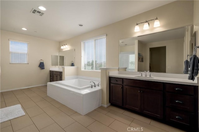 18094 Olivenhain Dr, Riverside, CA 92508 - full bath featuring healthy amount of natural light, a garden tub, two vanities, tile patterned floors, and recessed lighting