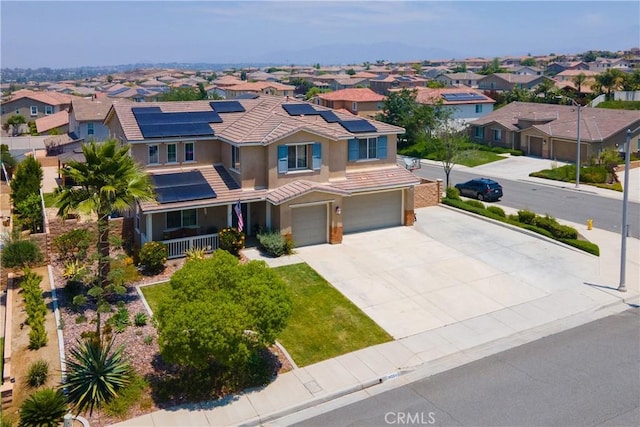 18094 Olivenhain Dr, Riverside, CA 92508 - view of front of home with a residential view, an attached garage, stucco siding, roof mounted solar panels, and driveway