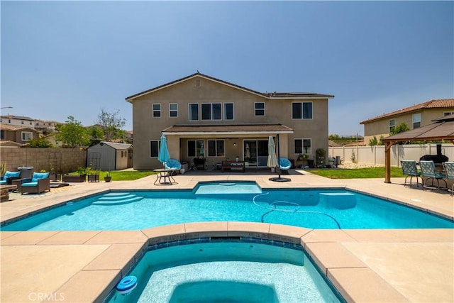 18094 Olivenhain Dr, Riverside, CA 92508 - view of swimming pool with a storage unit, an in-ground hot tub, and a patio