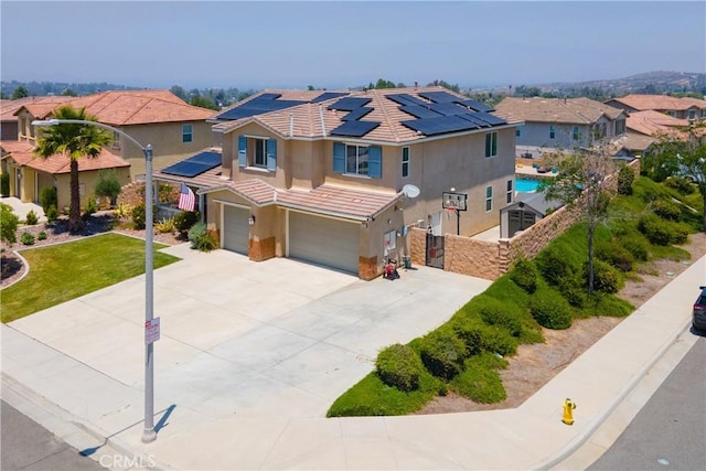 18094 Olivenhain Dr, Riverside, CA 92508 - view of front of home featuring stucco siding, a garage, a tiled roof, solar panels, and a residential view