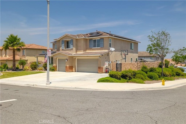 18094 Olivenhain Dr, Riverside, CA 92508 - view of front of house featuring stucco siding, an attached garage, solar panels, and concrete driveway