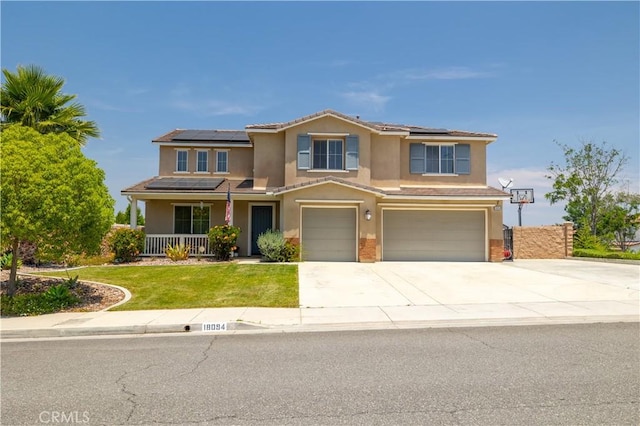 18094 Olivenhain Dr, Riverside, CA 92508 - view of front of house featuring stucco siding, a garage, covered porch, and roof mounted solar panels