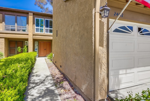 24412 Verena Ct, Mission Viejo, CA 92691 - property entrance with stucco siding, a garage, and crawl space