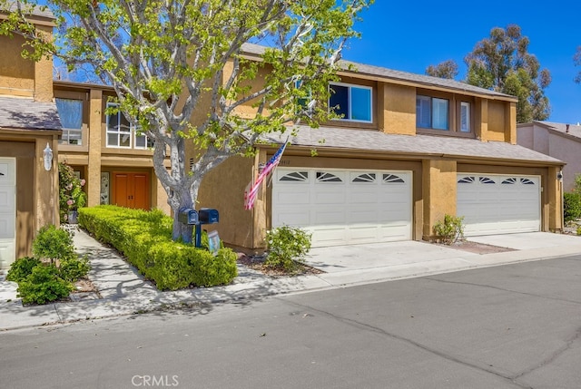 24412 Verena Ct, Mission Viejo, CA 92691 - townhome / multi-family property with stucco siding, a garage, and concrete driveway