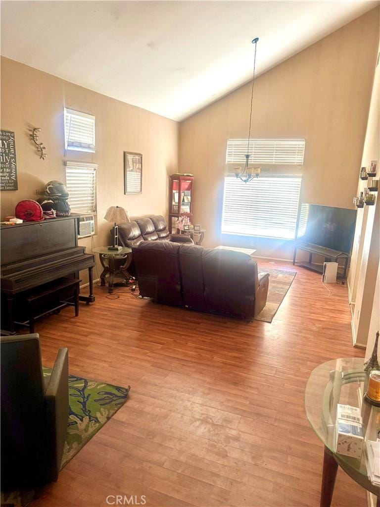 44686 Calle Hilario, Temecula, CA 92592 - living area with lofted ceiling, light wood-style floors, healthy amount of natural light, and cooling unit