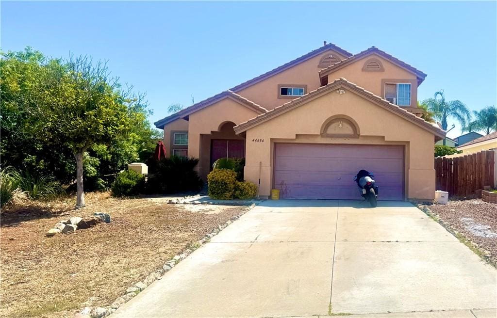 44686 Calle Hilario, Temecula, CA 92592 - mediterranean / spanish house featuring stucco siding, concrete driveway, and an attached garage