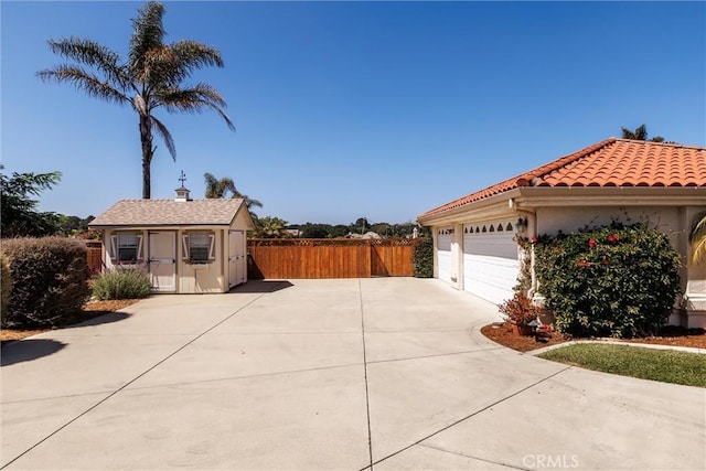620 Camino Roble, Nipomo, CA 93444 - view of side of property with driveway, an outbuilding, a tiled roof, a garage, and stucco siding