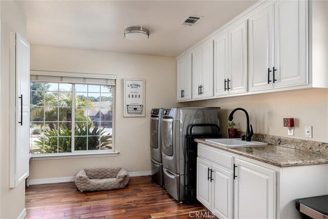 620 Camino Roble, Nipomo, CA 93444 - laundry area with independent washer and dryer, cabinet space, and dark wood-style flooring
