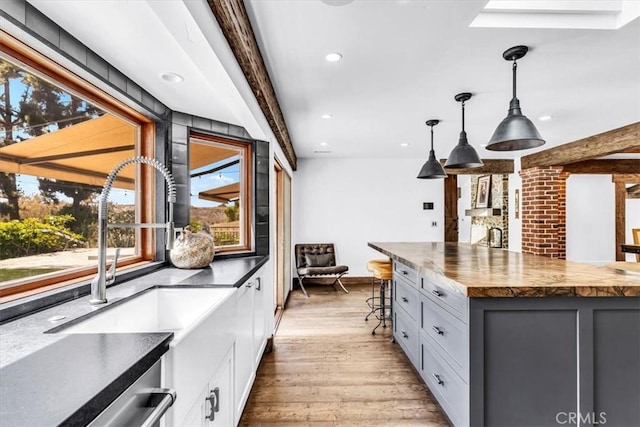27151 Mission Hills Dr, San Juan Capistrano, CA 92675 - kitchen featuring wooden counters, recessed lighting, white cabinets, light wood-type flooring, and hanging light fixtures
