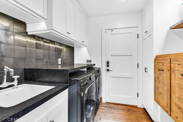 27151 Mission Hills Dr, San Juan Capistrano, CA 92675 - washroom with washer and clothes dryer, light wood-style floors, and cabinet space
