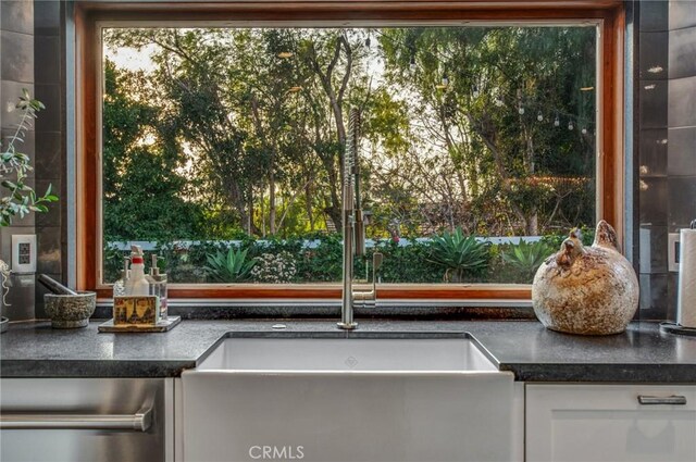 27151 Mission Hills Dr, San Juan Capistrano, CA 92675 - kitchen with white cabinetry, dark countertops, and dishwasher