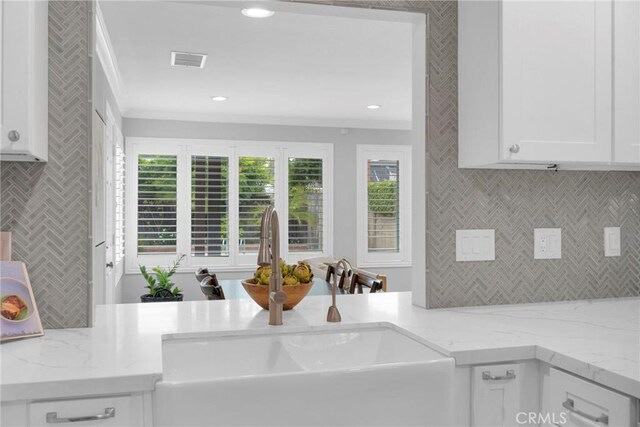 12012 Paseo Bonita, Los Alamitos, CA 90720 - kitchen with backsplash, white cabinets, ornamental molding, healthy amount of natural light, and recessed lighting