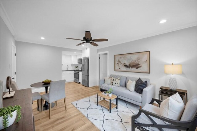 12012 Paseo Bonita, Los Alamitos, CA 90720 - living area with ceiling fan, recessed lighting, light wood-type flooring, and ornamental molding