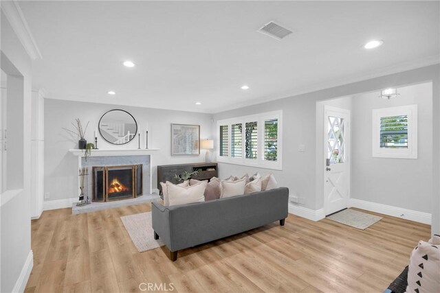 12012 Paseo Bonita, Los Alamitos, CA 90720 - living room featuring ornamental molding, a premium fireplace, recessed lighting, and light wood finished floors