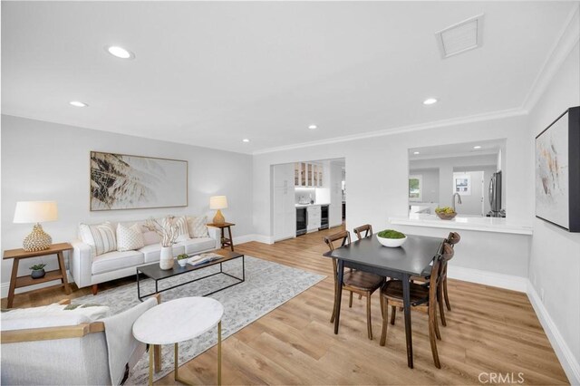 12012 Paseo Bonita, Los Alamitos, CA 90720 - living area featuring wood finished floors, crown molding, and recessed lighting