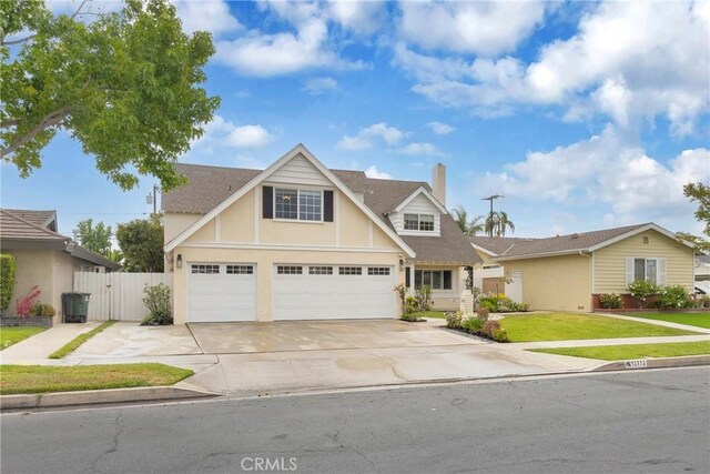 12012 Paseo Bonita, Los Alamitos, CA 90720 - traditional-style home featuring a chimney, concrete driveway, stucco siding, an attached garage, and roof with shingles