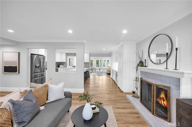 12012 Paseo Bonita, Los Alamitos, CA 90720 - living room featuring light wood-style flooring, a high end fireplace, recessed lighting, and crown molding