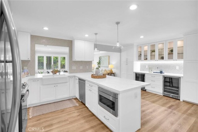 12012 Paseo Bonita, Los Alamitos, CA 90720 - kitchen featuring wine cooler, stainless steel appliances, decorative backsplash, a peninsula, and recessed lighting