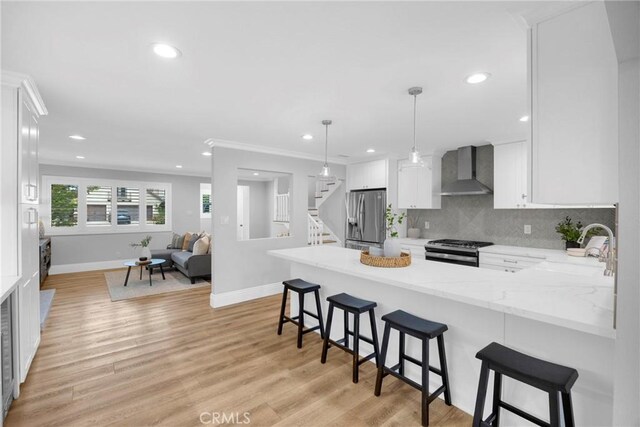 12012 Paseo Bonita, Los Alamitos, CA 90720 - kitchen with wall chimney exhaust hood, appliances with stainless steel finishes, white cabinetry, recessed lighting, and decorative backsplash