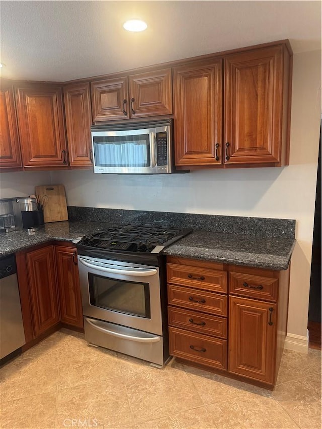 1398 Tartan Cir, Placentia, CA 92870 - kitchen with stainless steel appliances, brown cabinets, dark stone counters, and recessed lighting