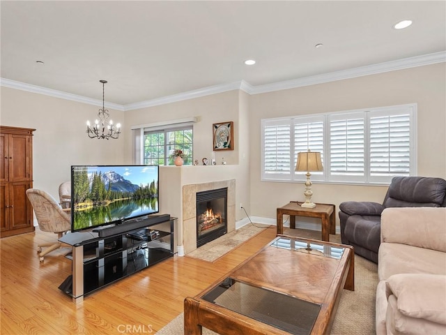 421 E Santa Anita Ave Unit 101, Burbank, CA 91501 - living area featuring light wood-type flooring, ornamental molding, a chandelier, and a tiled fireplace