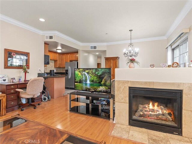 421 E Santa Anita Ave Unit 101, Burbank, CA 91501 - living area featuring crown molding, wood finished floors, a chandelier, and a tiled fireplace