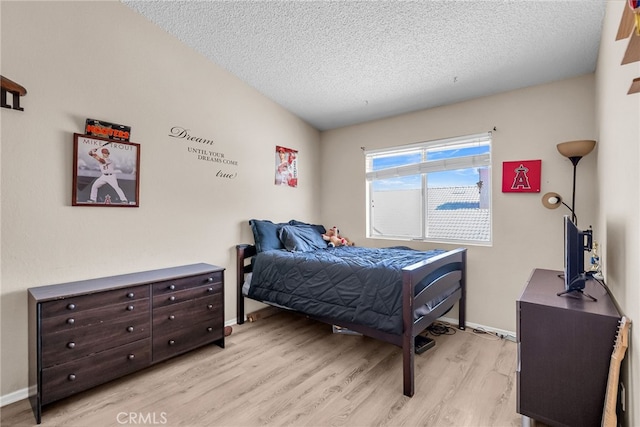 13180 Meteor Dr, Victorville, CA 92395 - bedroom with light wood-type flooring and a textured ceiling