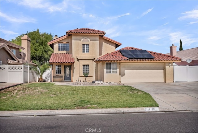 13180 Meteor Dr, Victorville, CA 92395 - mediterranean / spanish home featuring a garage, solar panels, concrete driveway, and stucco siding