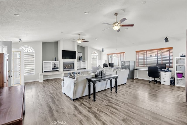 13180 Meteor Dr, Victorville, CA 92395 - living room with lofted ceiling, wood finished floors, an office area, plenty of natural light, and a textured ceiling