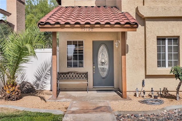 13180 Meteor Dr, Victorville, CA 92395 - view of exterior entry featuring stucco siding and a tile roof