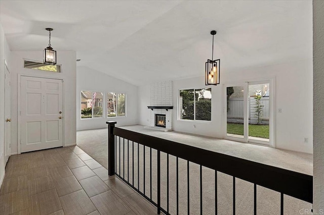 4772 Gateshead Rd, Carlsbad, CA 92010 - entryway with lofted ceiling, a fireplace, and carpet flooring