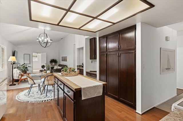 4772 Gateshead Rd, Carlsbad, CA 92010 - kitchen with light wood-style floors, dark brown cabinets, open floor plan, and a chandelier
